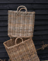 handmade  weaved rattan log basket  against wood shed  close up