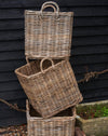 handmade  weaved rattan log basket  against wood shed 