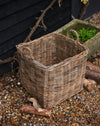 handmade  weaved rattan log basket  against wood shed 